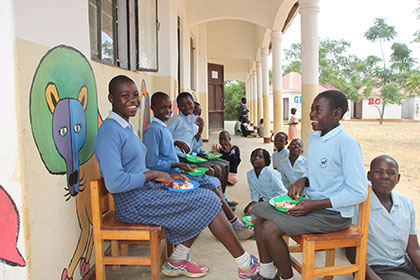 Children eating outside the School