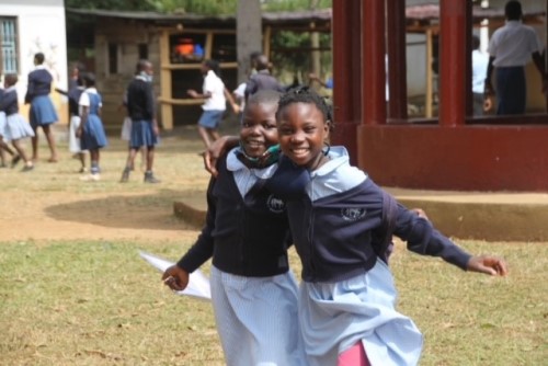 Two girls wearing headington school uniform